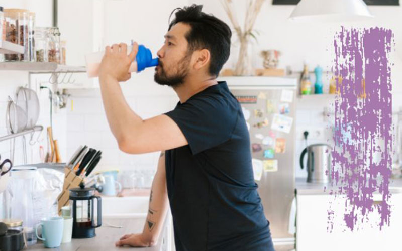 A man drinking a sports nutrition drink