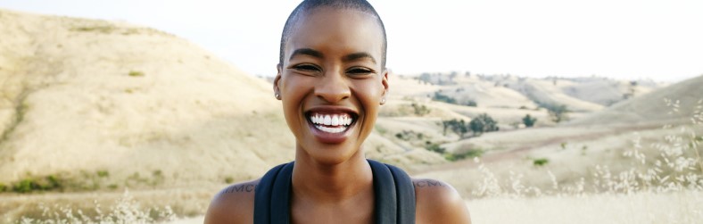 woman hiking and smiling